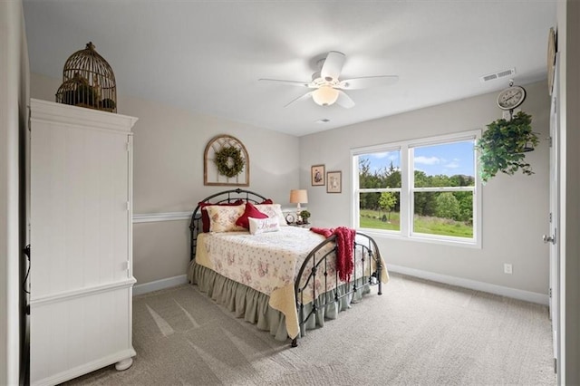 bedroom featuring baseboards, carpet floors, and a ceiling fan