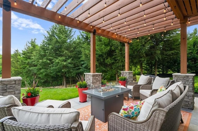 view of patio featuring an outdoor living space with a fire pit, a pergola, and view of wooded area
