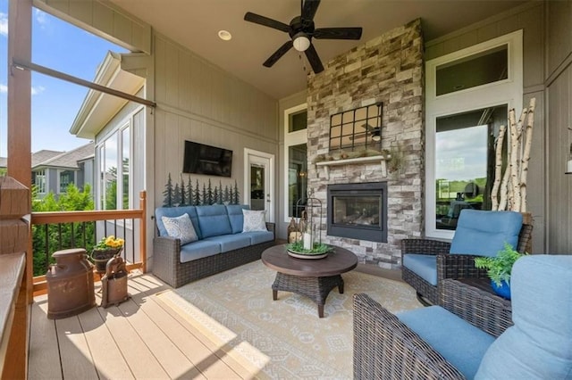 sunroom / solarium featuring an outdoor living space with a fireplace and a ceiling fan