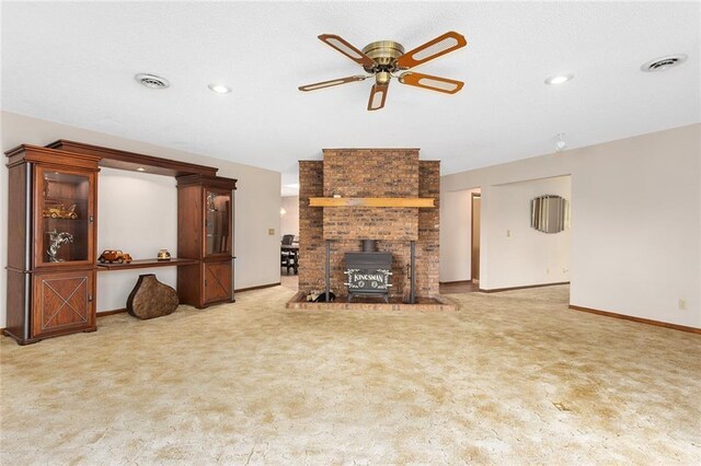 7613 NW Valley Rd, Kansas City, MO 64152 - unfurnished living room featuring ceiling fan, carpet flooring, baseboards, a wood stove, and recessed lighting