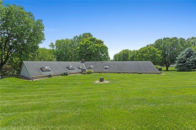 7613 NW Valley Rd, Kansas City, MO 64152 - rear view of property featuring a yard