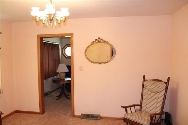 living area with baseboards, a chandelier, visible vents, and light colored carpet