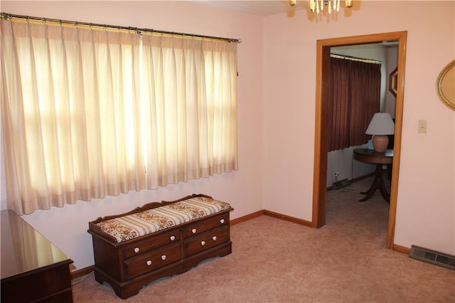 carpeted bedroom with baseboards, a chandelier, and visible vents