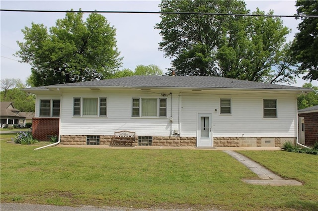 back of property with a lawn