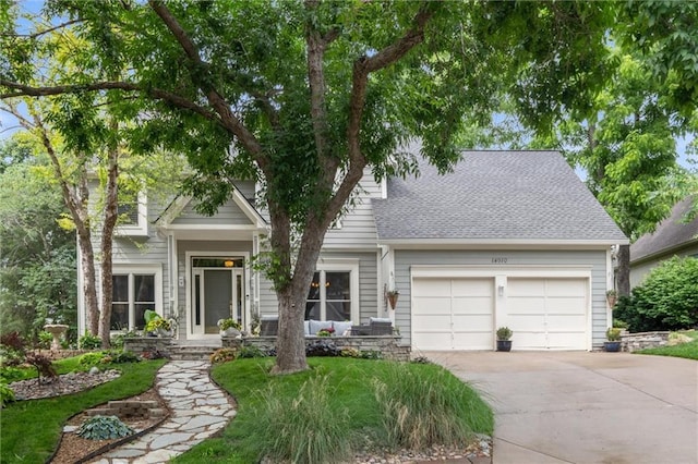 14910 Rhodes Cir, Lenexa, KS 66215 - view of front of property with an attached garage, driveway, and roof with shingles