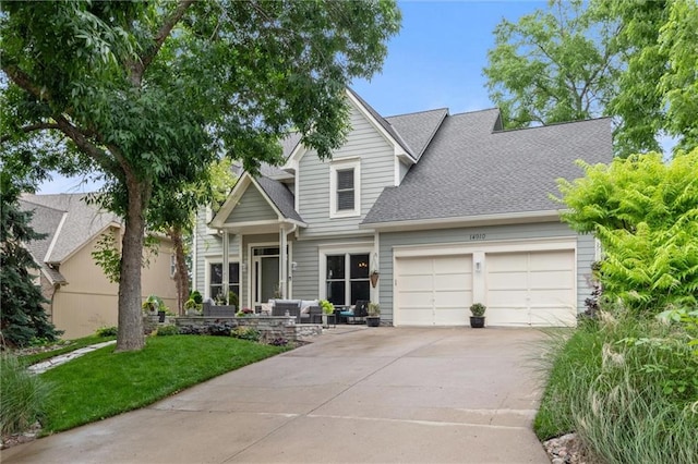 14910 Rhodes Cir, Lenexa, KS 66215 - view of front of house with an attached garage, concrete driveway, roof with shingles, and a front lawn