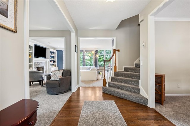 14910 Rhodes Cir, Lenexa, KS 66215 - foyer entrance featuring stairway, a fireplace, and wood finished floors