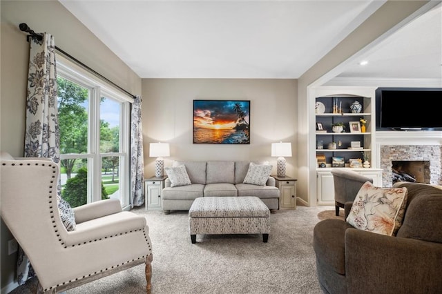 14910 Rhodes Cir, Lenexa, KS 66215 - carpeted living area featuring a stone fireplace and recessed lighting