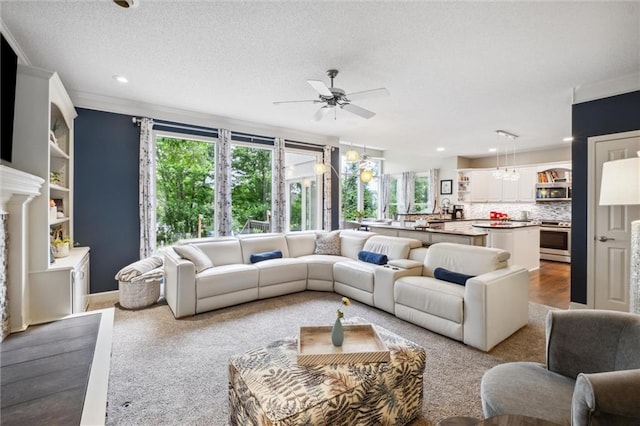 14910 Rhodes Cir, Lenexa, KS 66215 - living room with a ceiling fan, ornamental molding, recessed lighting, and a textured ceiling