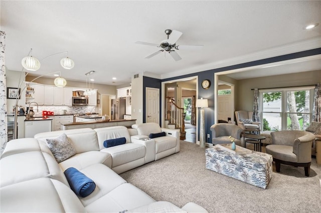 14910 Rhodes Cir, Lenexa, KS 66215 - living room featuring carpet flooring, a ceiling fan, ornamental molding, stairway, and recessed lighting