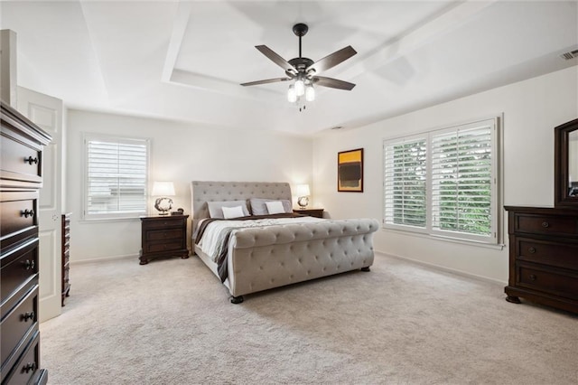 14910 Rhodes Cir, Lenexa, KS 66215 - bedroom with light colored carpet, a tray ceiling, and a ceiling fan