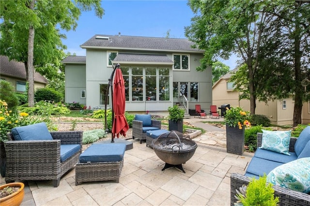 14910 Rhodes Cir, Lenexa, KS 66215 - back of house with a patio area, a shingled roof, a sunroom, and an outdoor living space with a fire pit