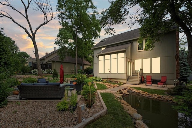 14910 Rhodes Cir, Lenexa, KS 66215 - rear view of property featuring a patio, an outdoor living space, and entry steps