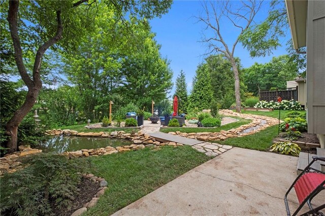 14910 Rhodes Cir, Lenexa, KS 66215 - view of green lawn with a patio