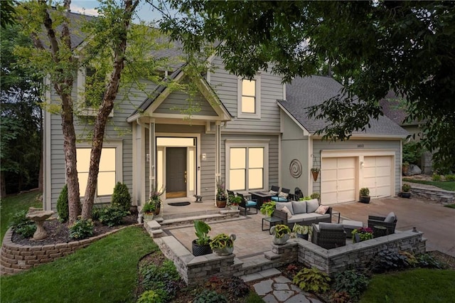 14910 Rhodes Cir, Lenexa, KS 66215 - view of front of house featuring driveway, outdoor lounge area, an attached garage, and roof with shingles
