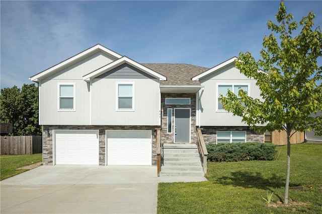 605 Carr St, Knob Noster, MO 65336 - bi-level home featuring stone siding, a garage, and driveway