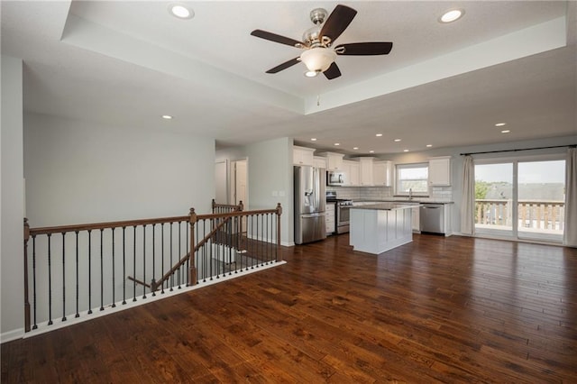 605 Carr St, Knob Noster, MO 65336 - unfurnished living room with dark wood finished floors, ceiling fan, recessed lighting, and baseboards
