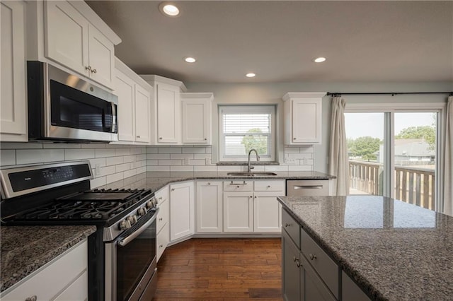 605 Carr St, Knob Noster, MO 65336 - kitchen with stainless steel appliances, a sink, recessed lighting, dark wood-type flooring, and tasteful backsplash
