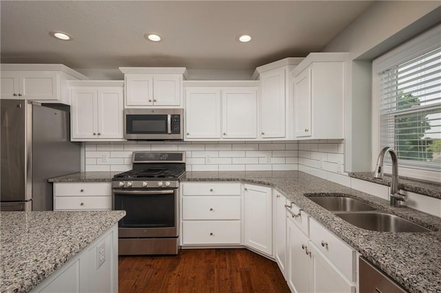 605 Carr St, Knob Noster, MO 65336 - kitchen with appliances with stainless steel finishes, a sink, white cabinets, and recessed lighting