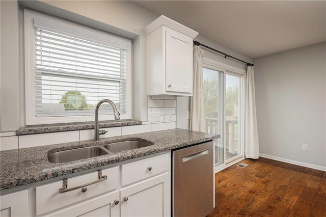 605 Carr St, Knob Noster, MO 65336 - kitchen featuring dishwasher, a sink, white cabinetry, dark stone countertops, and dark wood-type flooring