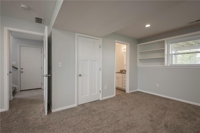 605 Carr St, Knob Noster, MO 65336 - unfurnished bedroom featuring light carpet, baseboards, ensuite bathroom, and recessed lighting