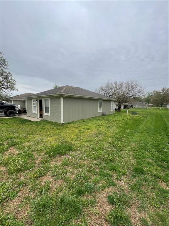 view of property exterior featuring a lawn