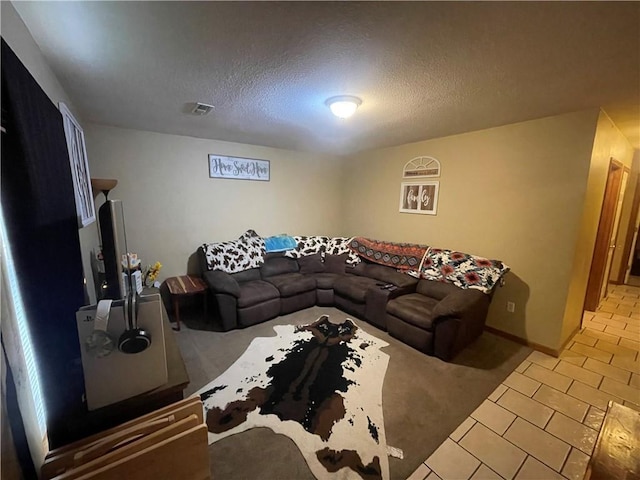 tiled living area with carpet floors and a textured ceiling