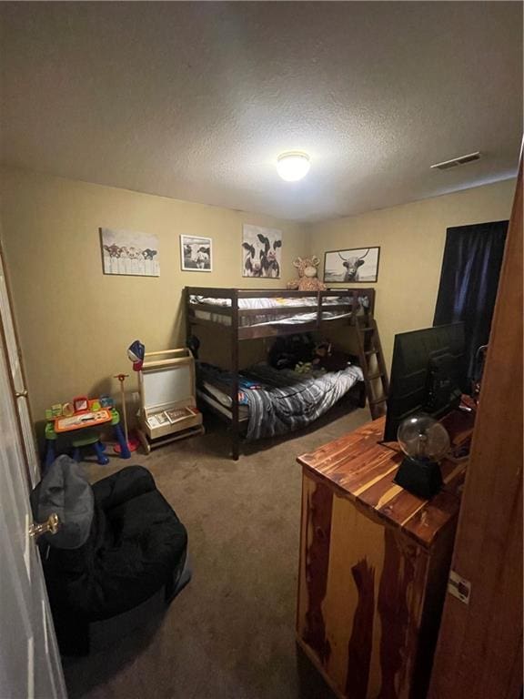 carpeted bedroom with a textured ceiling