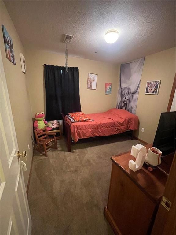 carpeted bedroom featuring a textured ceiling