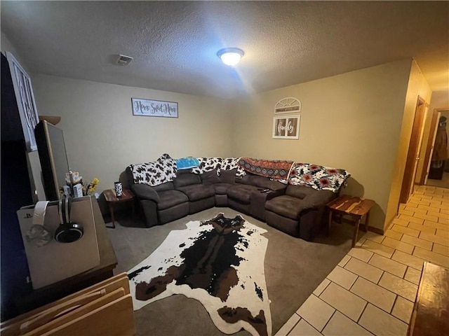 tiled living area featuring a textured ceiling and carpet