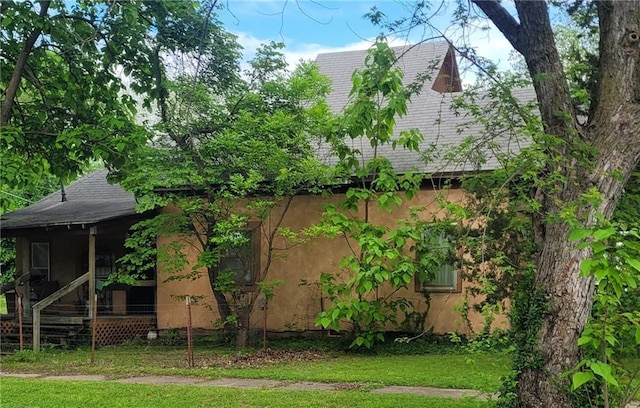 view of side of home featuring stucco siding