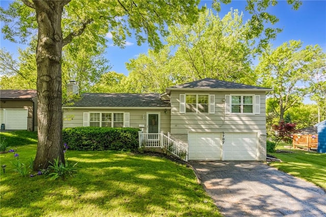 5707 W 101st Ter, Overland Park, KS 66207 - tri-level home featuring a garage, asphalt driveway, a chimney, and a front yard