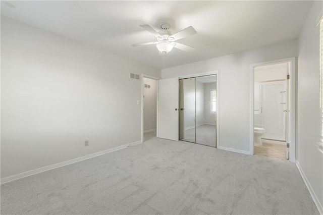 5707 W 101st Ter, Overland Park, KS 66207 - unfurnished bedroom with carpet flooring, a closet, ensuite bathroom, baseboards, and a ceiling fan