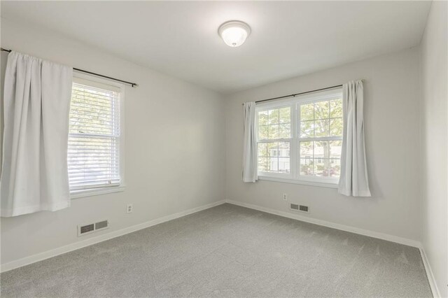 5707 W 101st Ter, Overland Park, KS 66207 - unfurnished room featuring plenty of natural light, carpet floors, and baseboards