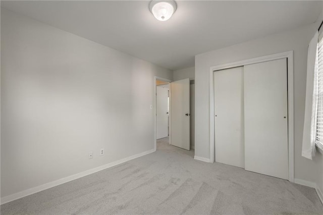 5707 W 101st Ter, Overland Park, KS 66207 - unfurnished bedroom featuring light colored carpet, a closet, and baseboards