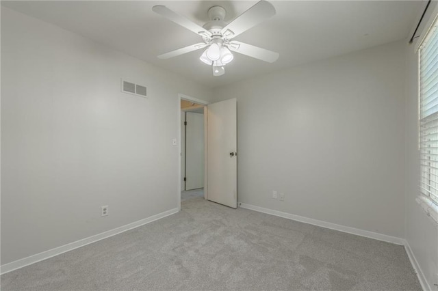 5707 W 101st Ter, Overland Park, KS 66207 - spare room featuring light carpet, a ceiling fan, and baseboards