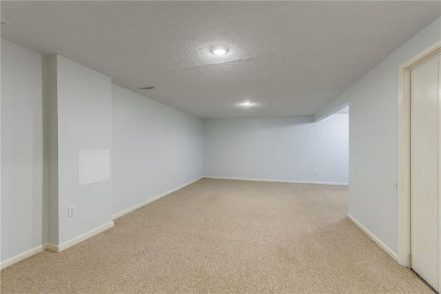 5707 W 101st Ter, Overland Park, KS 66207 - finished below grade area with light carpet, a textured ceiling, baseboards, and recessed lighting