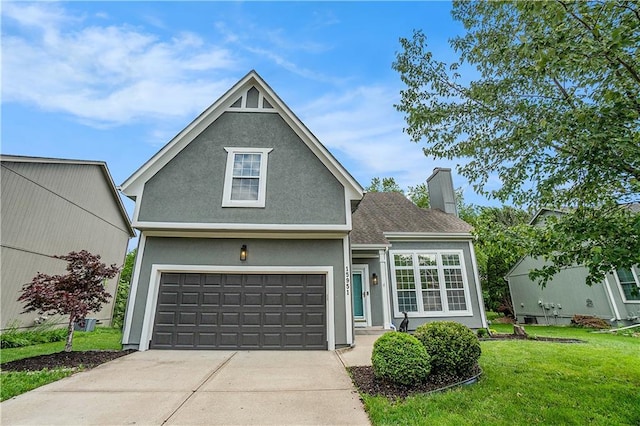 15951 S Avalon St, Olathe, KS 66062 - traditional-style home featuring a front yard, a chimney, concrete driveway, stucco siding, and a garage