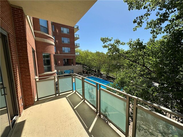 4950 Central St Unit 102, Kansas City, MO 64112 - balcony featuring view of pool area and area for grilling