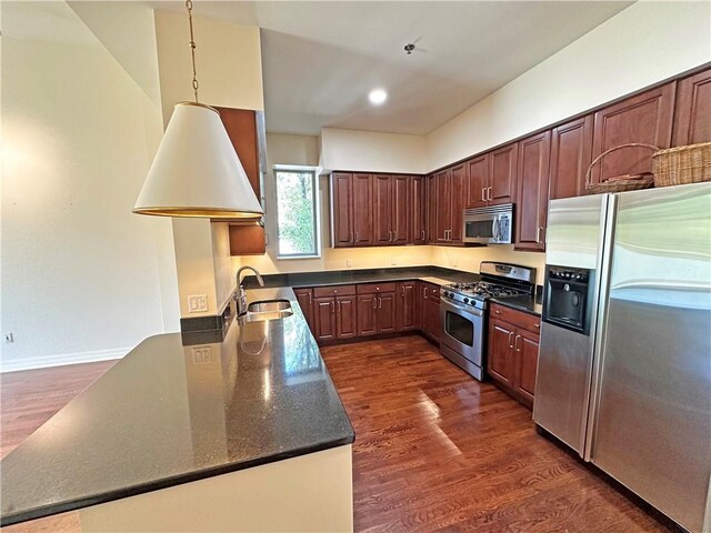 4950 Central St Unit 102, Kansas City, MO 64112 - kitchen with stainless steel appliances, a sink, dark wood-style flooring, and recessed lighting