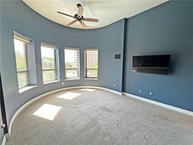 4950 Central St Unit 102, Kansas City, MO 64112 - spare room featuring carpet floors, ceiling fan, and baseboards