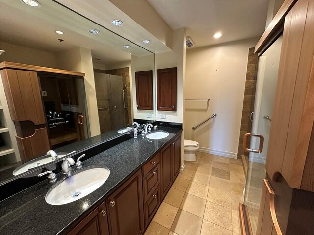 4950 Central St Unit 102, Kansas City, MO 64112 - full bath with a shower stall, baseboards, toilet, double vanity, and recessed lighting