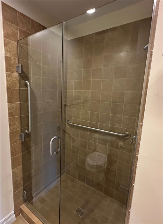 4950 Central St Unit 102, Kansas City, MO 64112 - full bathroom with a shower stall and recessed lighting