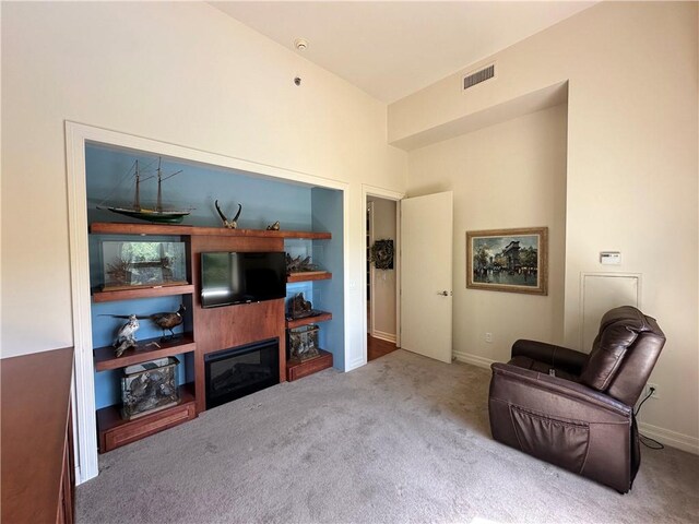 4950 Central St Unit 102, Kansas City, MO 64112 - sitting room featuring carpet flooring, baseboards, and a glass covered fireplace