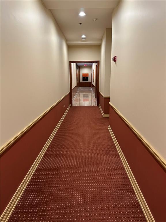4950 Central St Unit 102, Kansas City, MO 64112 - hallway featuring carpet floors