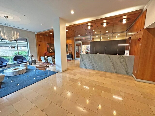 4950 Central St Unit 102, Kansas City, MO 64112 - welcome area with a chandelier, recessed lighting, and wood walls