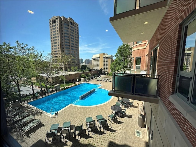 4950 Central St Unit 102, Kansas City, MO 64112 - community pool with a patio, fence, and a city view