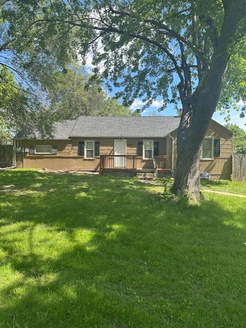 3805 Laurel Ave, Kansas City, MO 64133 - back of house featuring a deck and a lawn