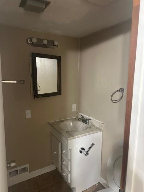 3805 Laurel Ave, Kansas City, MO 64133 - half bath with toilet, vanity, visible vents, tile patterned floors, and baseboards