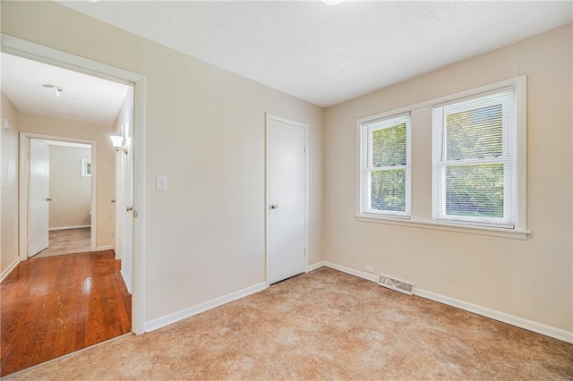 6132 N Eugene Field Rd, Kansas City, MO 64119 - unfurnished bedroom with baseboards and light carpet